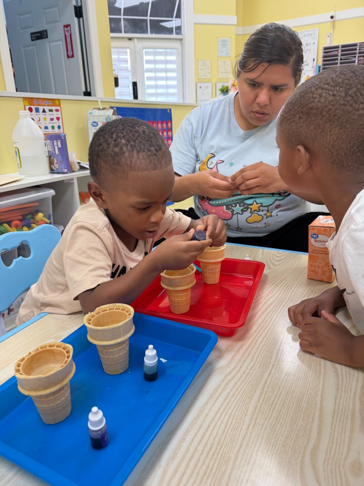 Children practicing everyday skills with their teacher at Dreamland