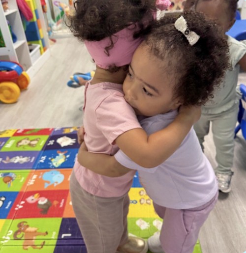 Two children sharing a hug at Dreamland