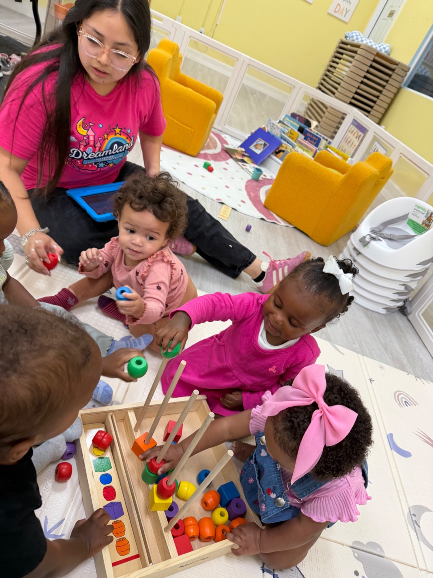 A Dreamland teacher and children exploring a colorful hands-on sorting activity